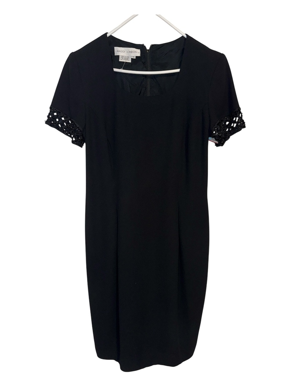 Maggy London Black pleated Midi dress. Lined. Size 10.  Beaded short sleeve.